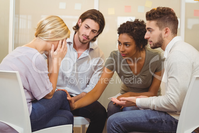 Colleagues supporting tensed businessman