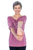 Portrait of happy mature woman stretching