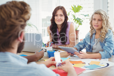Business professionals discussing in creative office