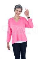Portrait of cheerful mature woman showing OK sign