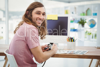 Portrait of happy hipster using camera