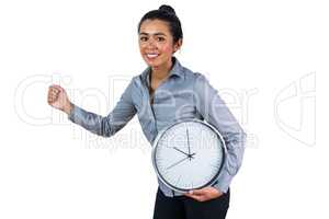 Smiling woman holding a large clock
