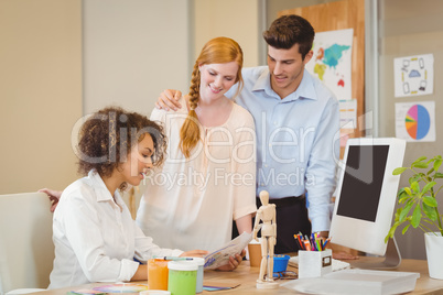 Businesswoman showing documents to colleagues