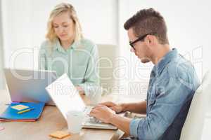 Serious man and woman working on laptop