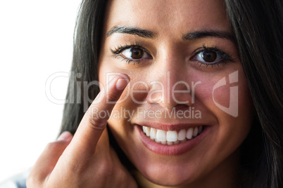 Smiling woman with a contact lens