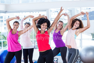 Portrait of women exercising with arms raised