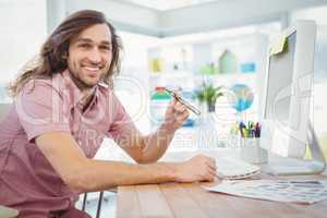 Portrait of happy hipster holding electronic cigarette