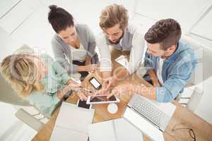 Overhead view of business people with digital tablet