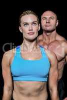 Muscular woman and man looking up