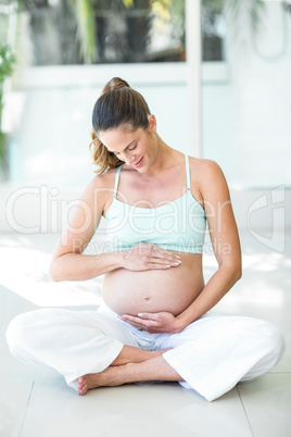 Happy woman sitting with legs crossed