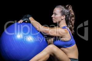 Side view of sporty woman with exercise ball