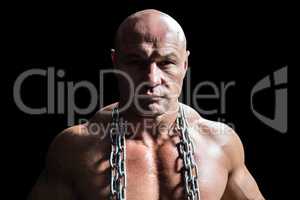 Portrait of confident muscular man with chain