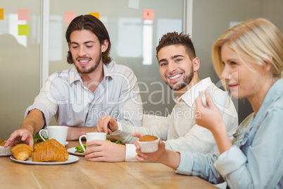 Businessman with colleagues having snacks