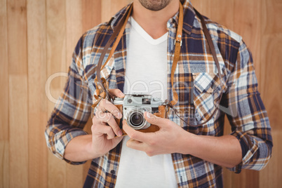 Mid section of hipster using camera