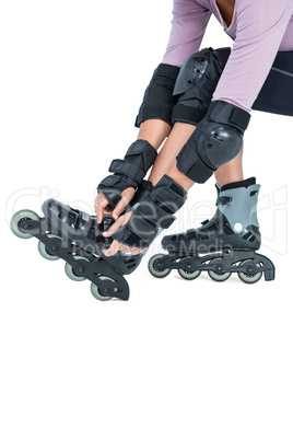 Low section of sporty woman wearing inline skates