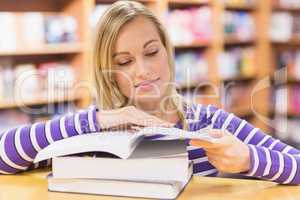 Young woman reading book at desk