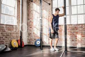 Man leaning on a pole