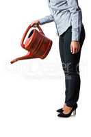 Happy woman holding a watering can