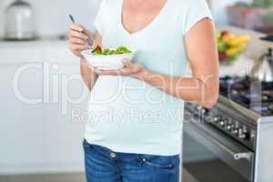 Midsection of woman with salad bowl
