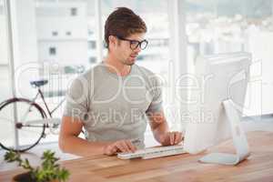 Hipster working on computer at desk