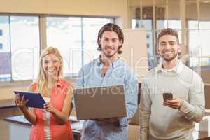 Portrait of business people using various technologies