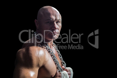 Portrait of confident bodybuilder man holding chain