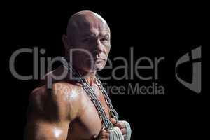 Portrait of confident bodybuilder man holding chain