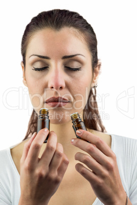 Close-up of female patient smelling bottles of medicine