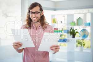 Happy hipster looking at documents