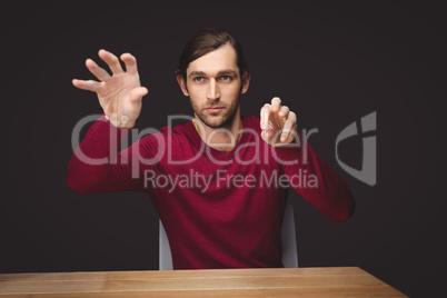 Man gesturing while sitting at desk