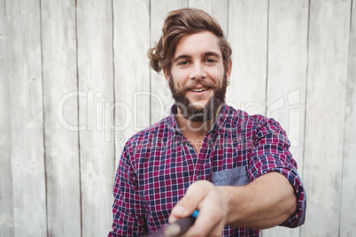 Portrait of hipster using selfie stick