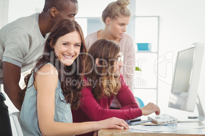 Portrait of smiling woman sitting at desk in office Portrait of smiling woman sitting at desk in office