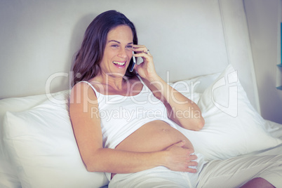 Cheerful woman listening on mobile phone