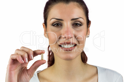 Close-up portrait of happy woman holding pill