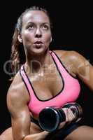 Fit woman working out with dumbbell