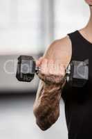 Cropped image of man lifting dumbbell