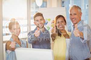 Business people showing thumbs