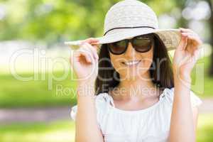 Cheerful young woman with sunglasses and hat
