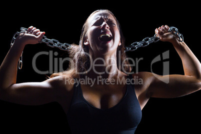 Aggressive female athlete holding chain