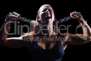 Aggressive female athlete holding chain