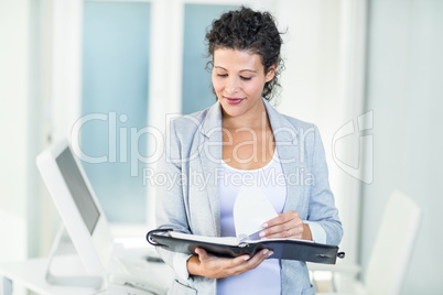 Beautiful businesswoman holding document