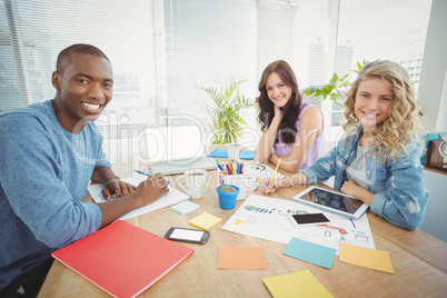 Portrait of happy business people working at desk