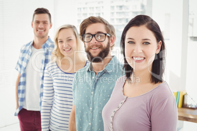 Portrait of smiling business people standing in row