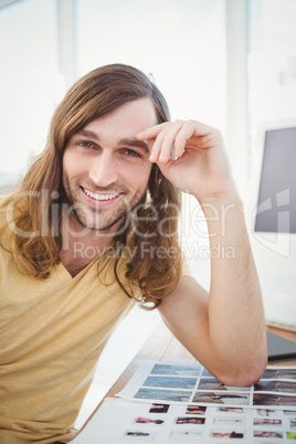 Portrait of happy hipster with head in hands