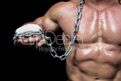 Midsection of man fist with chain