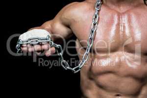 Midsection of man fist with chain