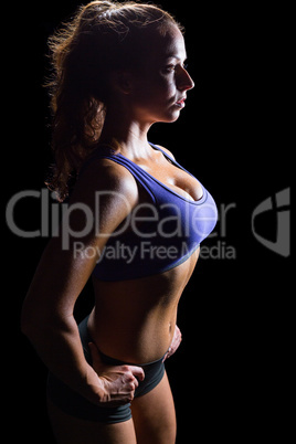 Side view of sexy athlete with hands on hip