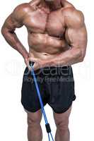 Midsection of bodybuilder pulling elastic rope
