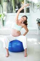 Portrait of woman stretching on ball