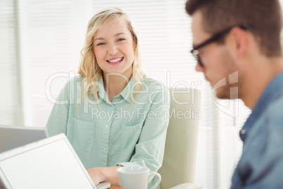 Portrait of smiling woman sitting on chair